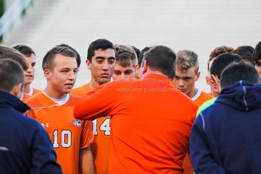 Pre-game huddle with Coach Rusty Oglesby. From left, juniors Nick Mueller and Hector Duron and senior Jack Griffiths.