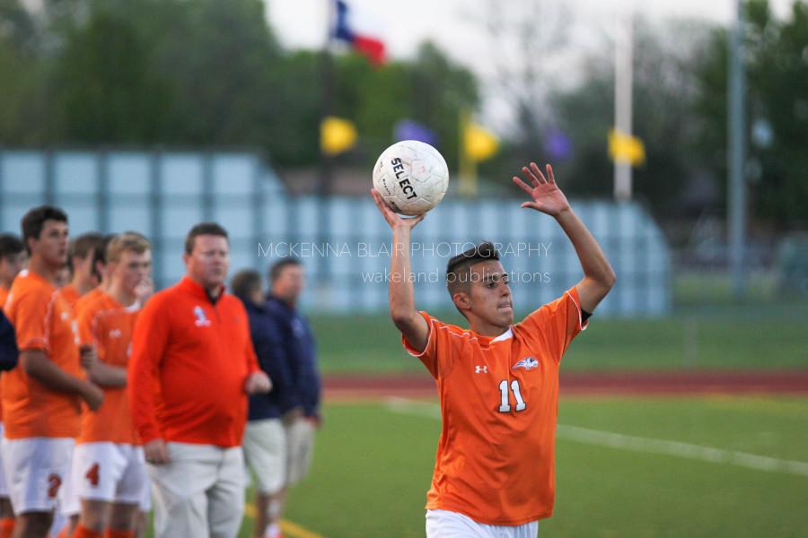 With his team looking on in earnest, junior Noa Cuellar facilitates a throw in.