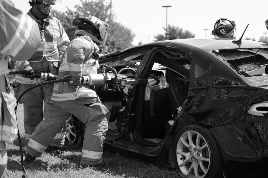 Firefighters use the jaws of life to open the car in order to extract Wilkins.