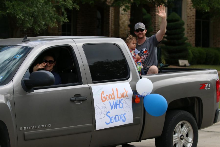 Coach Bell and his family travel through Griffin Parc to cheer for the seniors.