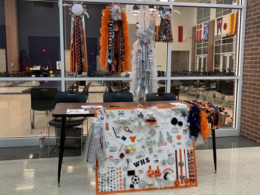 The+cheer+team+sells+mums+and+garters+to+students+so+they+can+easily++design+what+they+want+for+their+date.+Wakeland+homecoming+is+Sept.+17%2C+2021.+Photo+by+Kate+Nosel.