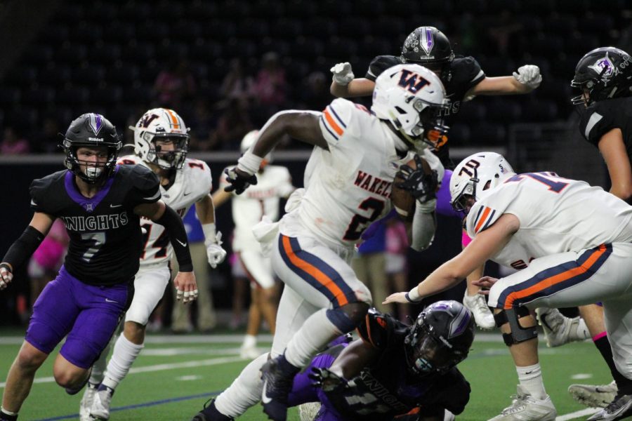 Senior+Jared+White+escapes+the+Knights+with+a+big+run+for+a+first+down.+Wakeland+defeated+Independence+49-0+on+Oct.+7+at+The+Ford+Center.+Photo+by+Sarah+Hazelip.