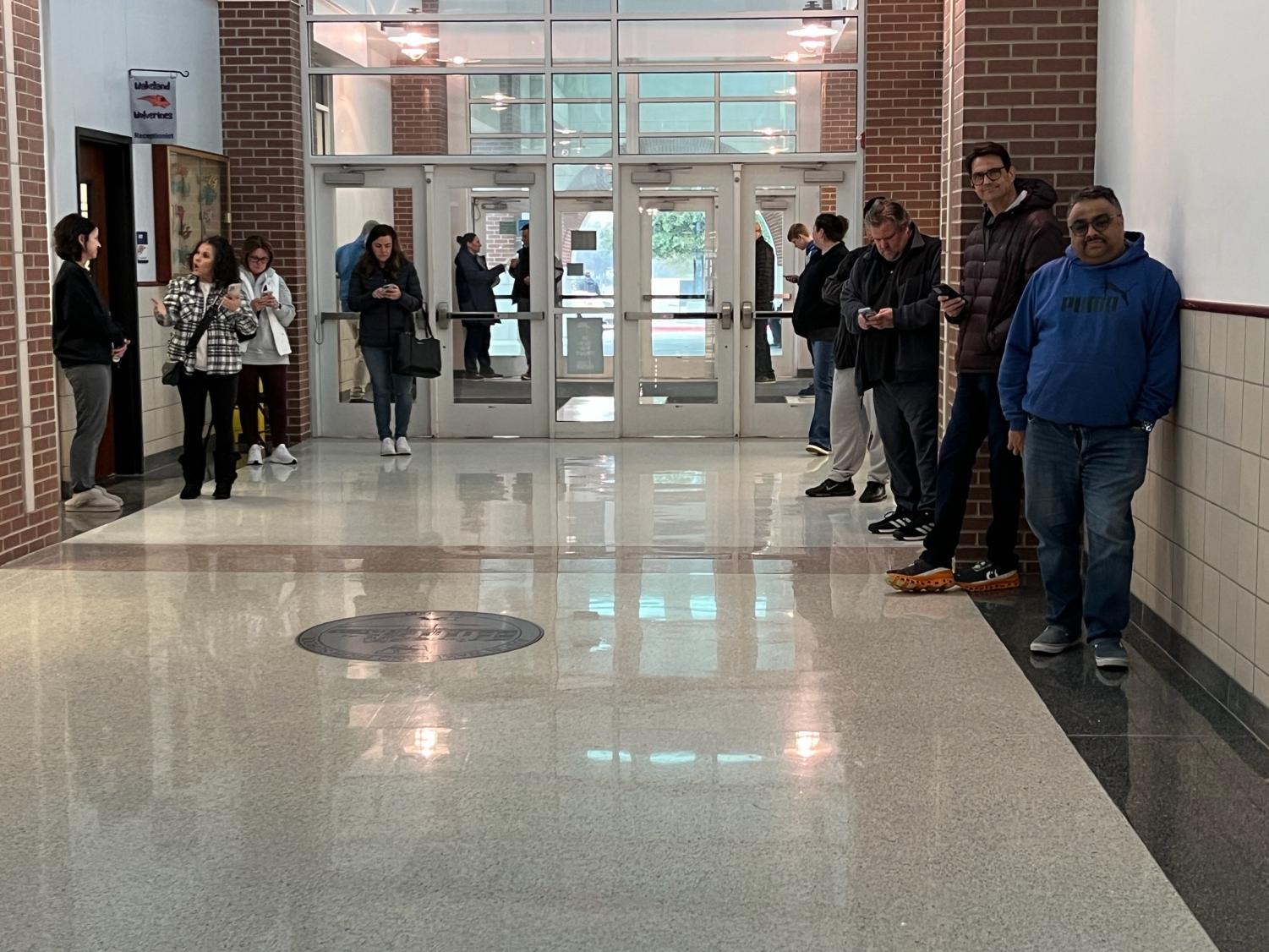 Parents file into the front of the school and wait to pick up their student(s) amidst this afternoon’s winter weather.