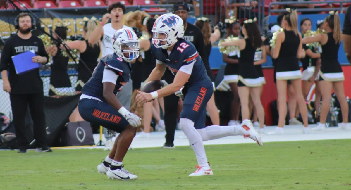 Quarterback Senior Jayden Maples with the hand off in the Wolverines 24-14 win over The Colony on Thursday, Sept. 4, at Toyota Stadium.