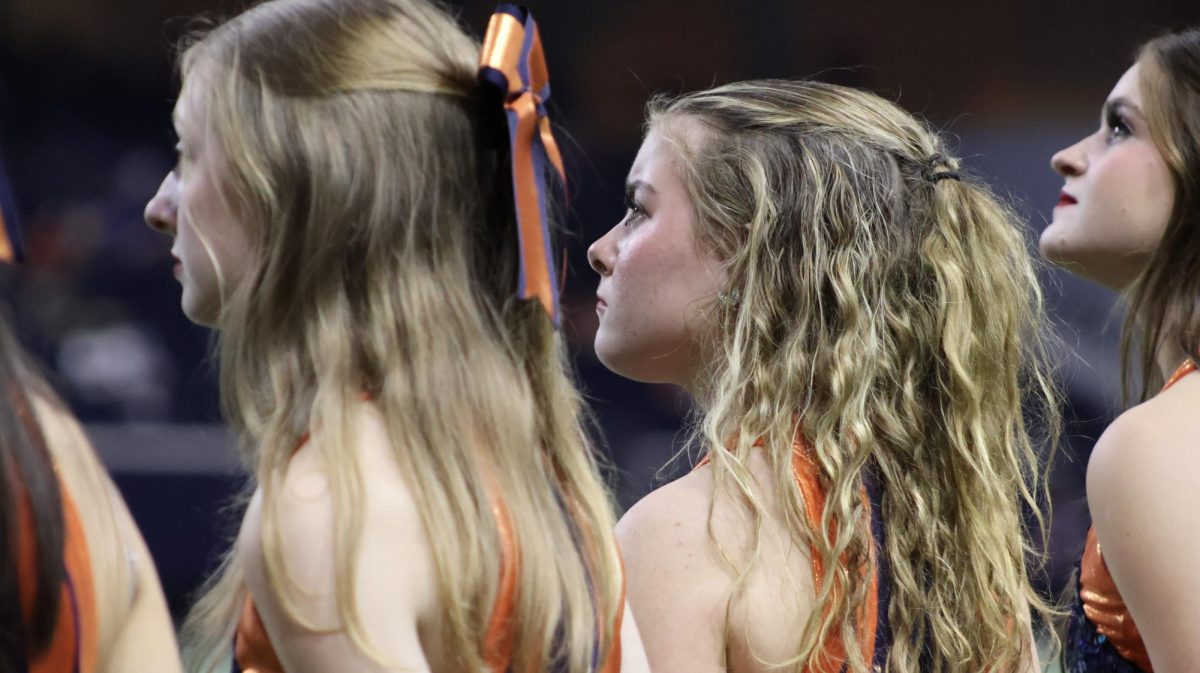 Ella Bischoff watches the opposing team's drill team routine before taking the field at the first Playoff game of her sophomore season.
